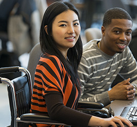 Diverse group of students using computers.