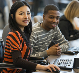 Diverse group of students using computers.