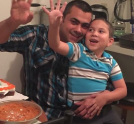 Arabic father and young son waving