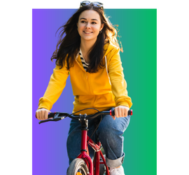 Teen Caucasian girl with long brown hair wearing a yellow jacket riding a red bike