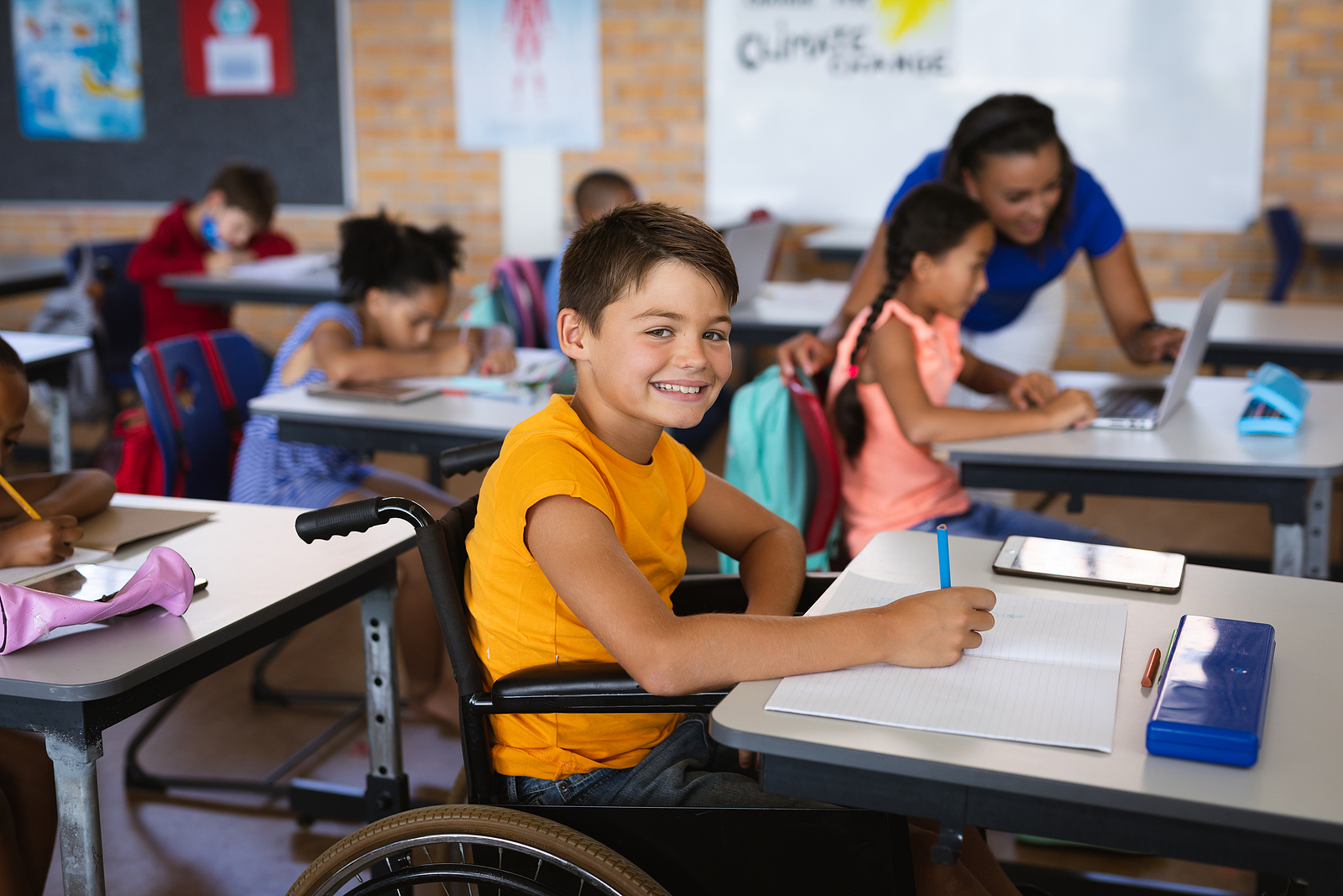 Portrait of caucasian boy smiling while sitting on wheelchair