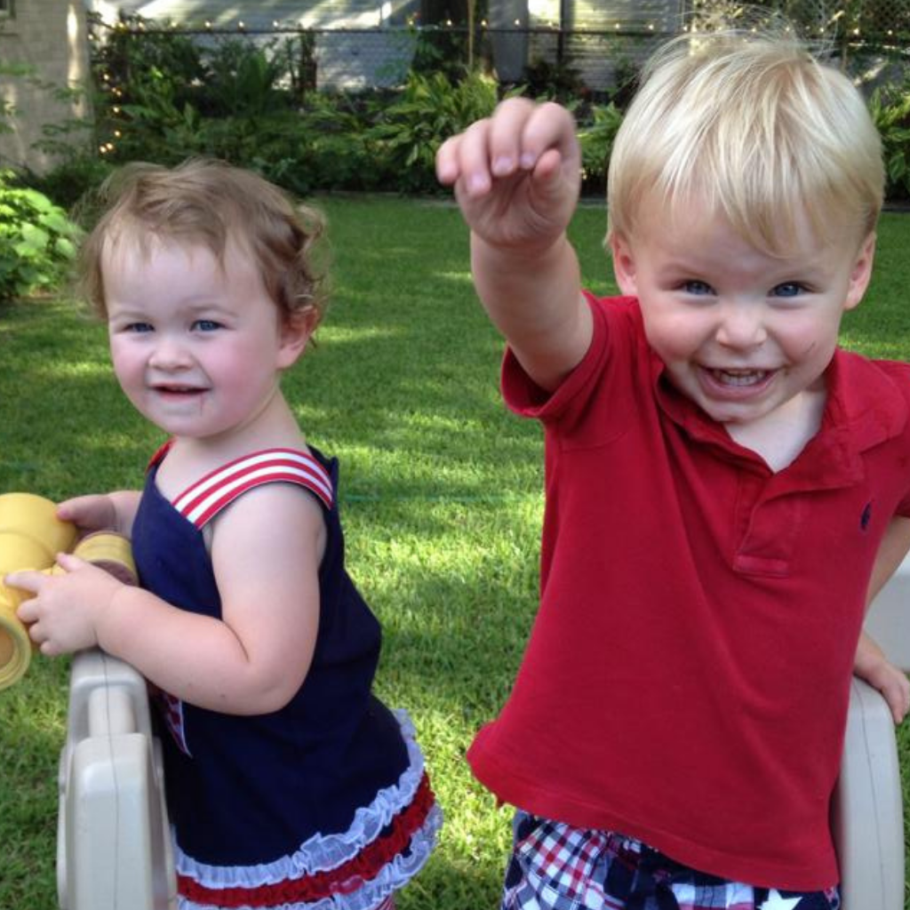 Toddler girl brown hair Toddler boy with blonde hair both are wearing red white an blue clothing Toddler girl brown hair Toddler boy with blonde hair both are wearing red white an blue clothing
